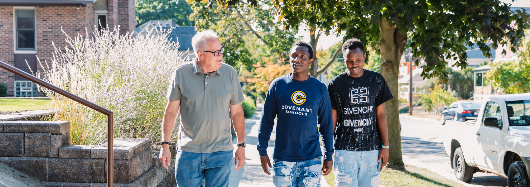 A Bethany volunteer walks with two refugee youth